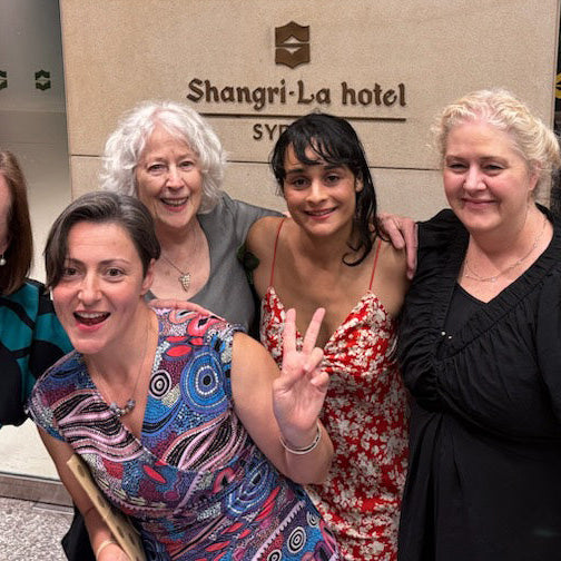 The NatureArt Lab team posing outside of the Shangri-La Hotel, Sydney where the Awards Australia Gala Event was held. The team members are dressed in cocktail outfits and smiling.